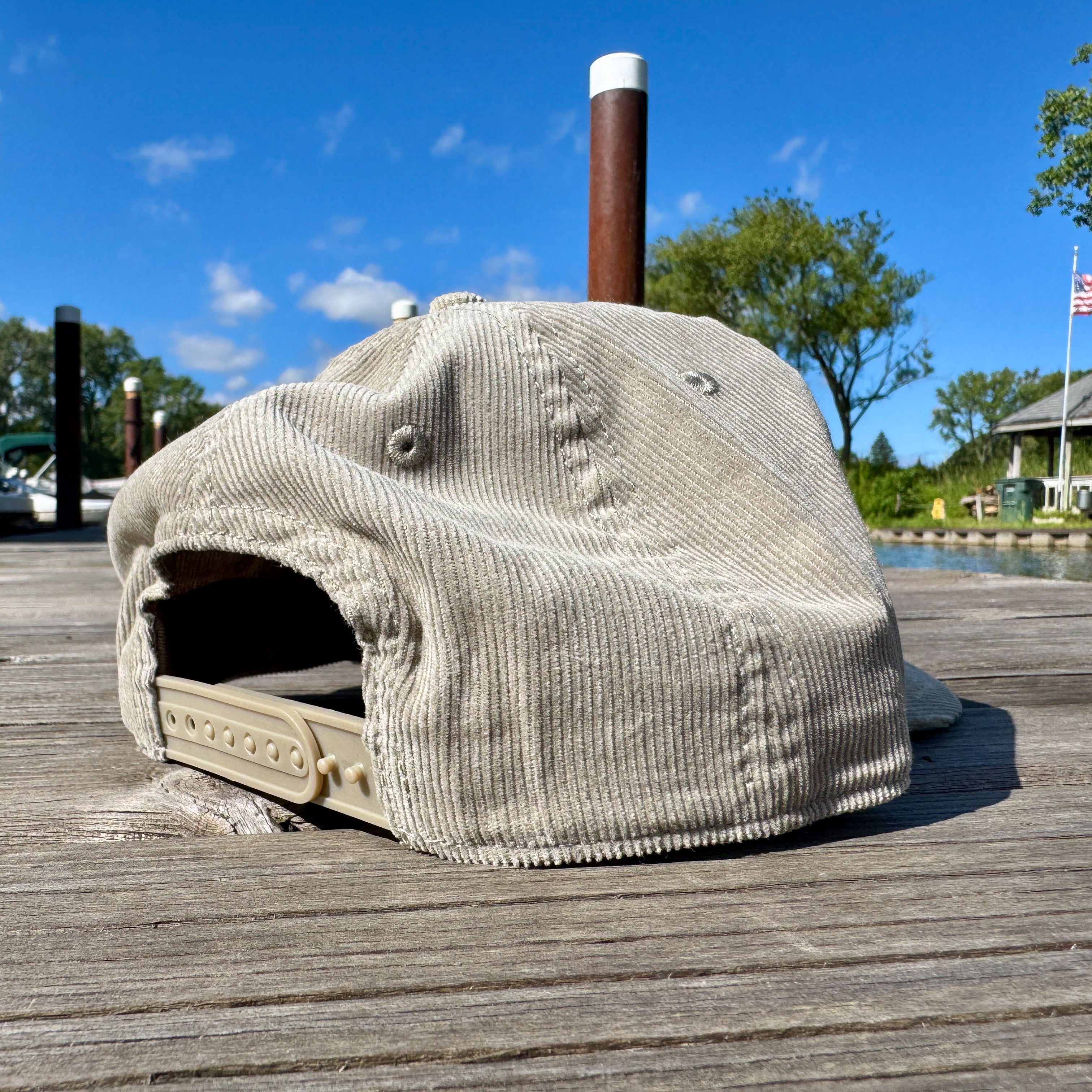 Backside of a corduroy cap on a wooden dock.