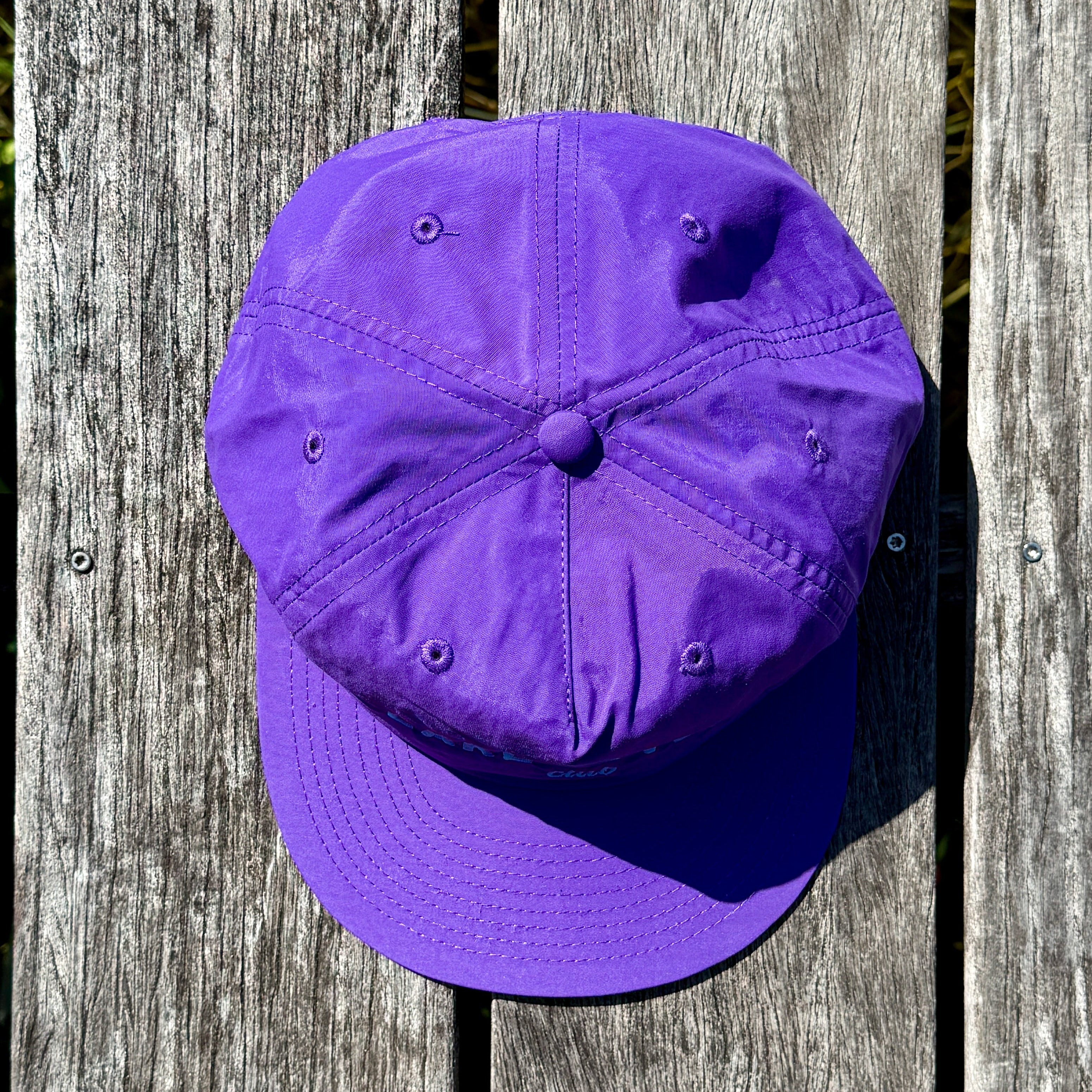 Purple cap on a wooden surface
