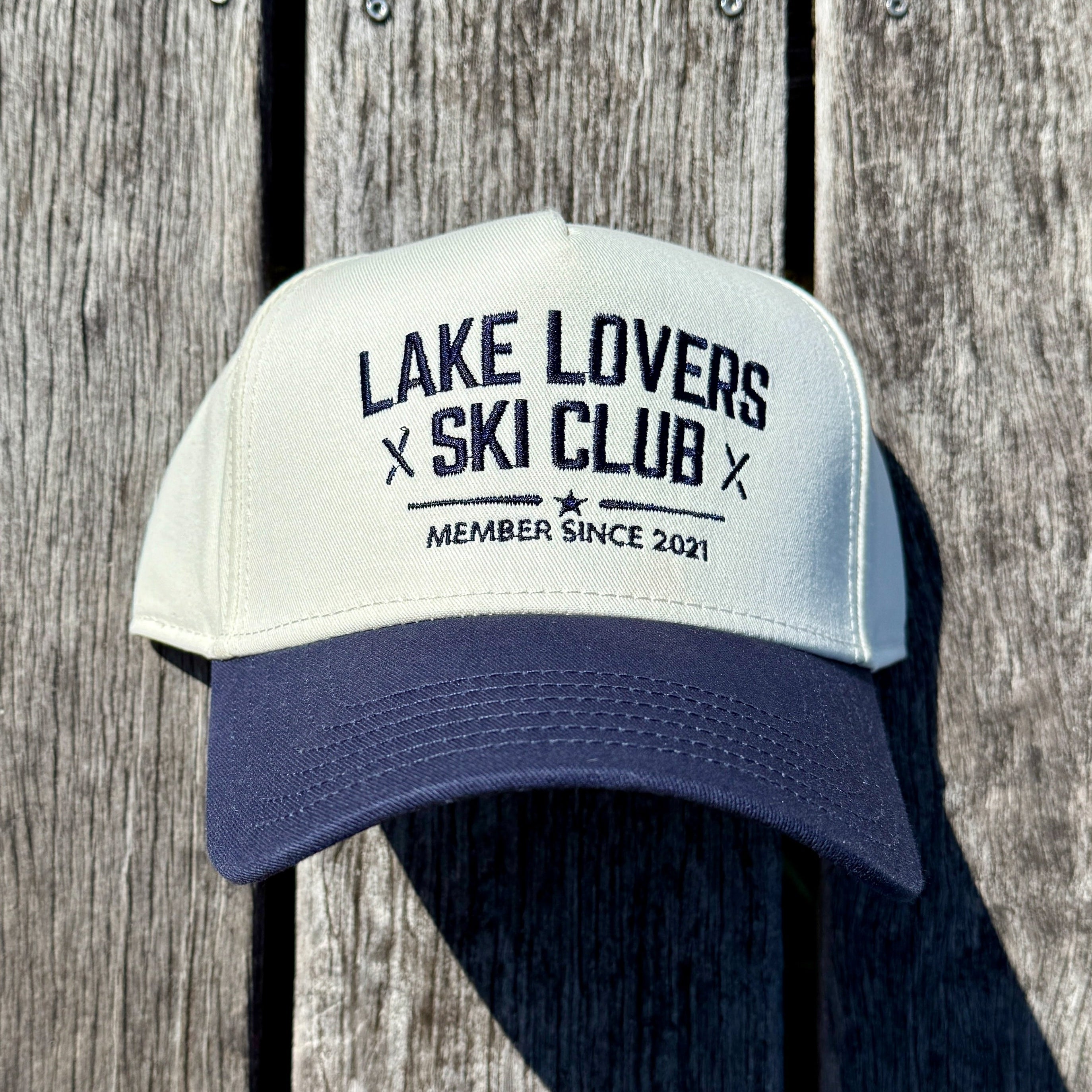 Cap with 'Lake Lovers Ski Club' text on a wooden background